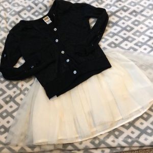 Girls cream tool skirt and black sweater.